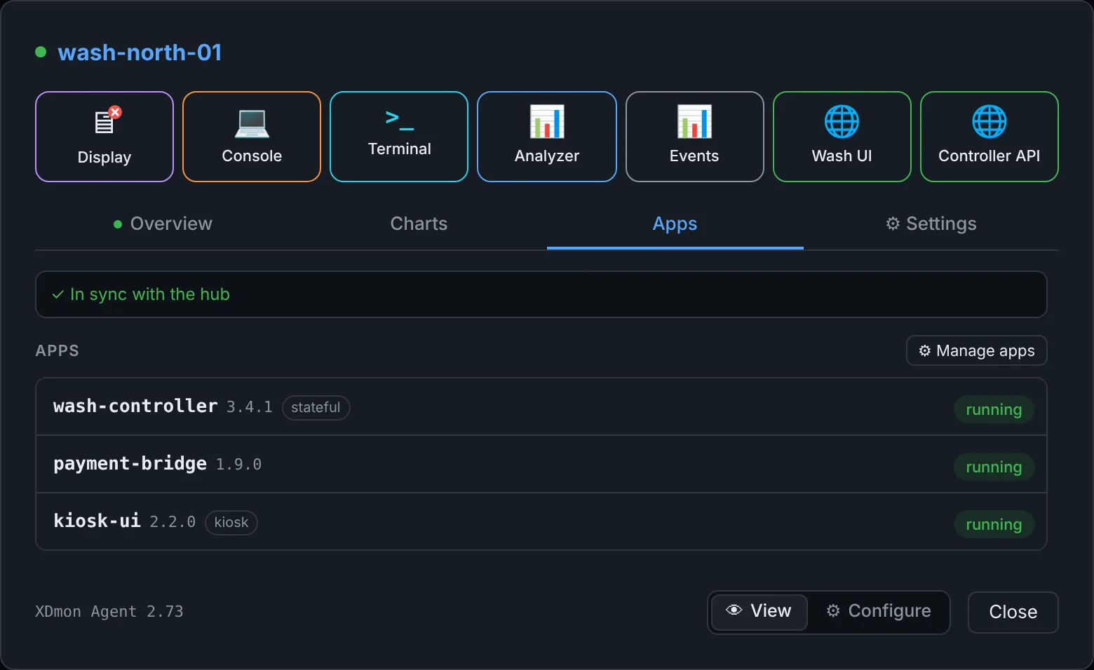 Apps tab listing wash-controller, payment-bridge and kiosk-ui, all running, in sync with the hub