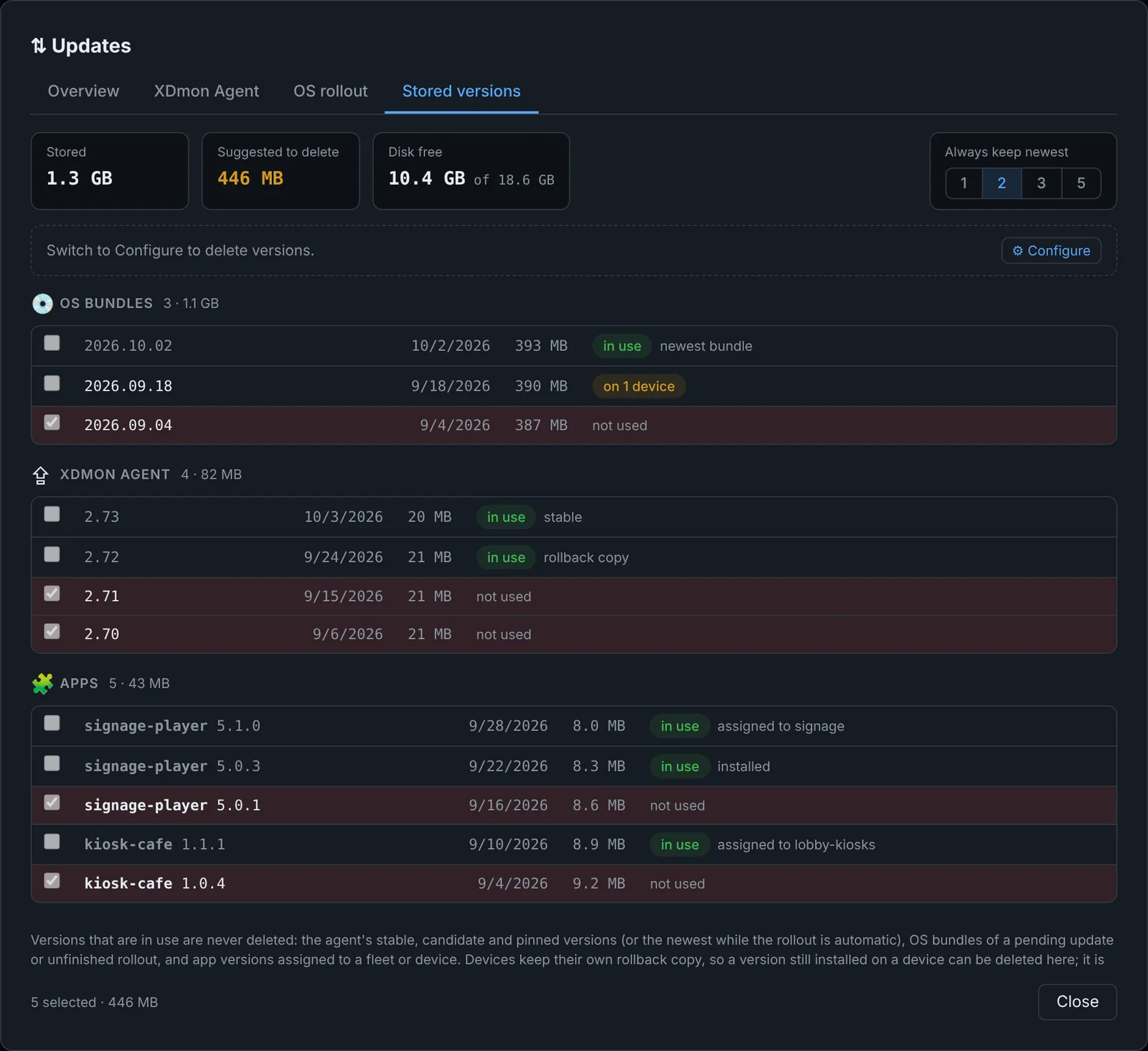 Stored versions with OS bundles, agent releases and app packages, in-use badges and selected old versions